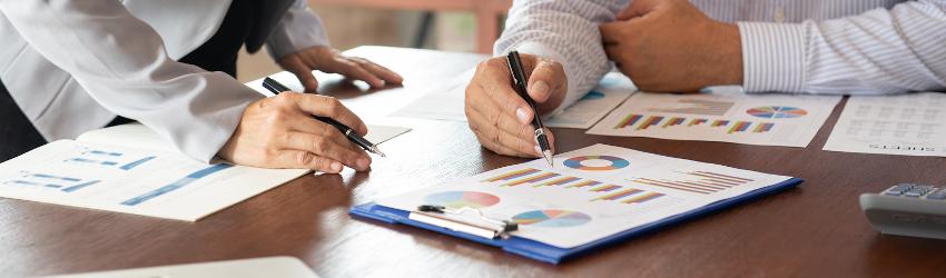 Two public accountants reviewing financials at a desk